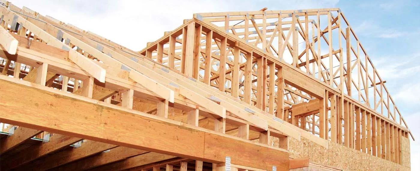 Wood roof framing meeting exterior wall framing on a commercial building.